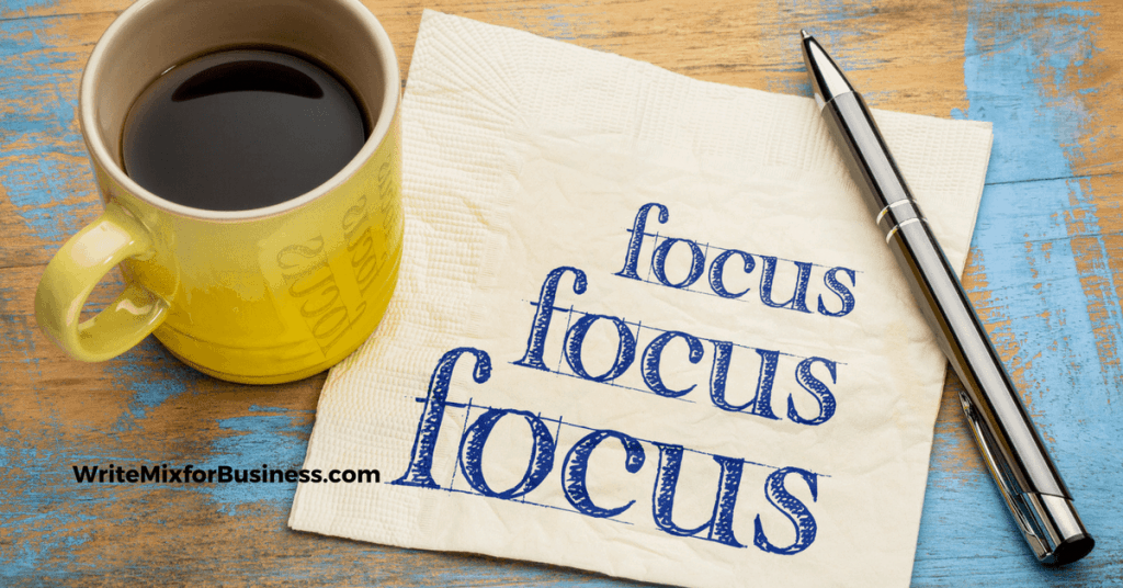 Focus theme shown with coffee cup and napkin with word "Focus" written on it 3 times WriteMixforBusiness.com post by Sue-Ann Bubacz